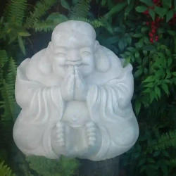 Chinese smiling Buddha, small, white, concrete.